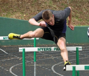 Queens men's track athlete Johannes Reimann works on his hurdling technique during a recent practice at Myers Park High School. CREDIT: Bill Kiser